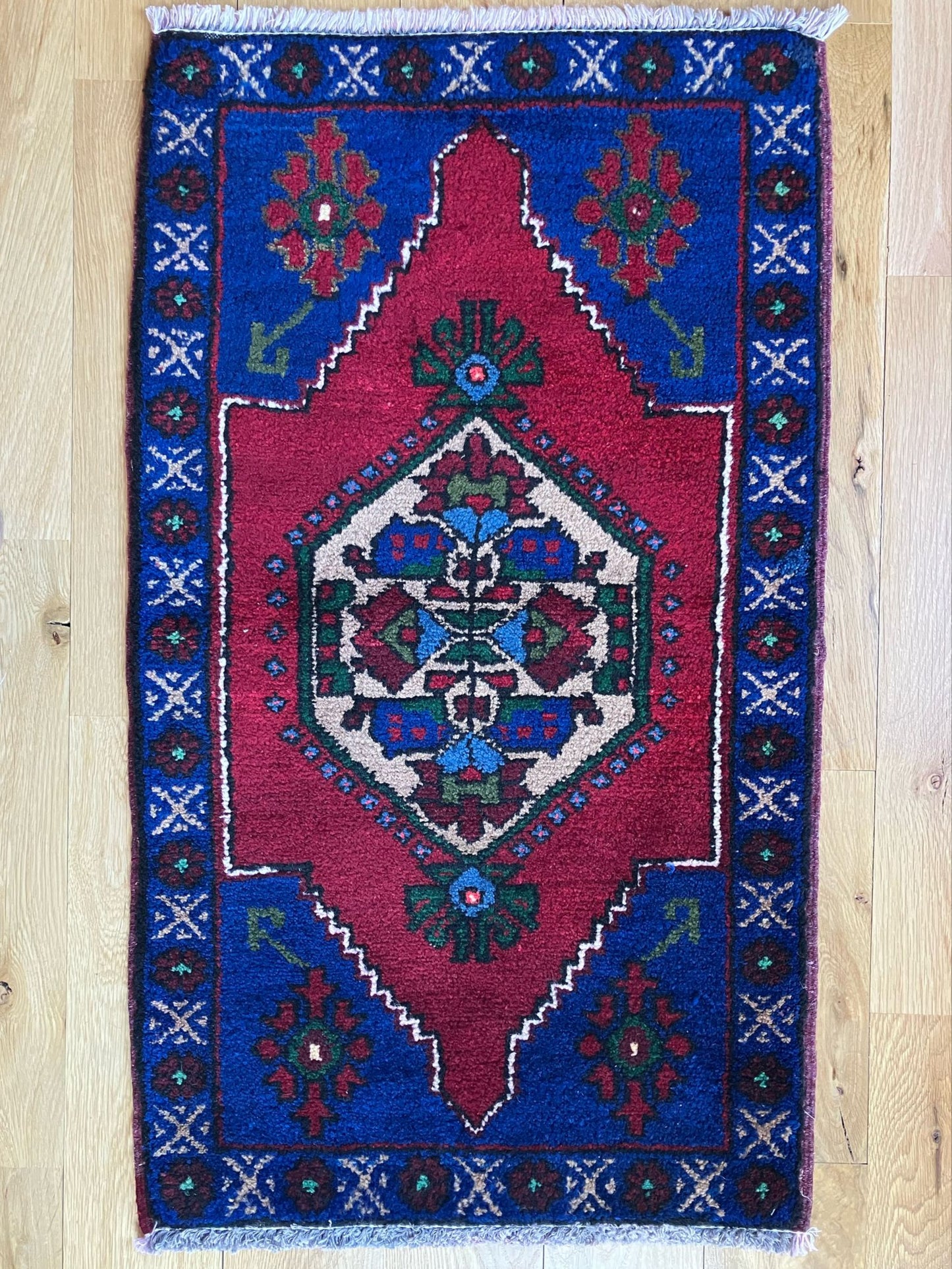 Handmade vintage Turkish entryway rug made of cotton foundation and a wool pile, featuring red and blue colors.