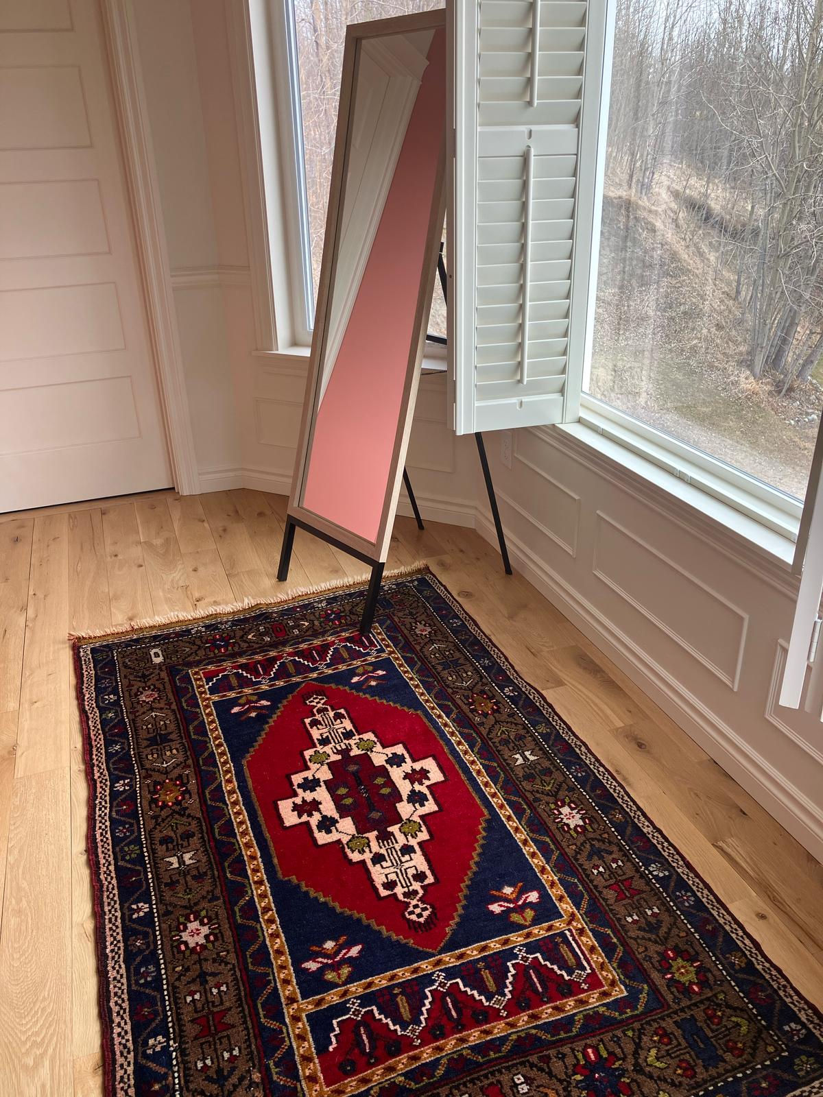 Handmade vintage Turkish medium rug made of 100% wool, featuring red, blue, and brown colors.