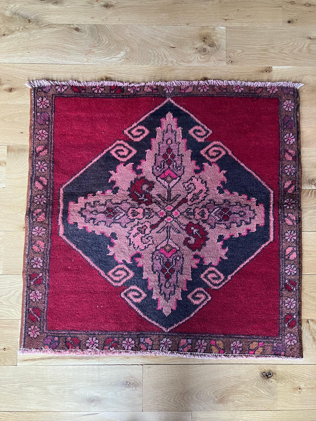 Handmade vintage Turkish entryway rug made of a cotton foundation and a wool pile, featuring red and black colors.