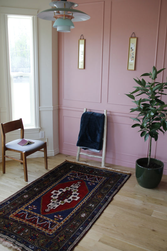 Handmade vintage Turkish medium rug made of 100% wool, featuring red, blue, and brown colors.    