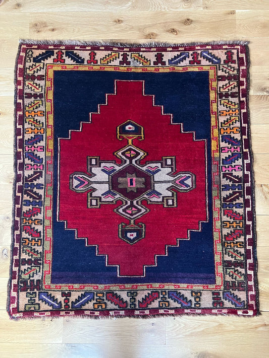 Handmade antique Turkish entryway rug made of a cotton foundation and a wool pile, featuring  red and blue colors.