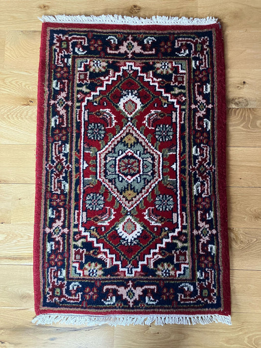Handmade vintage Persian entryway rug made of a cotton foundation and a wool pile, featuring  red and blue colors.