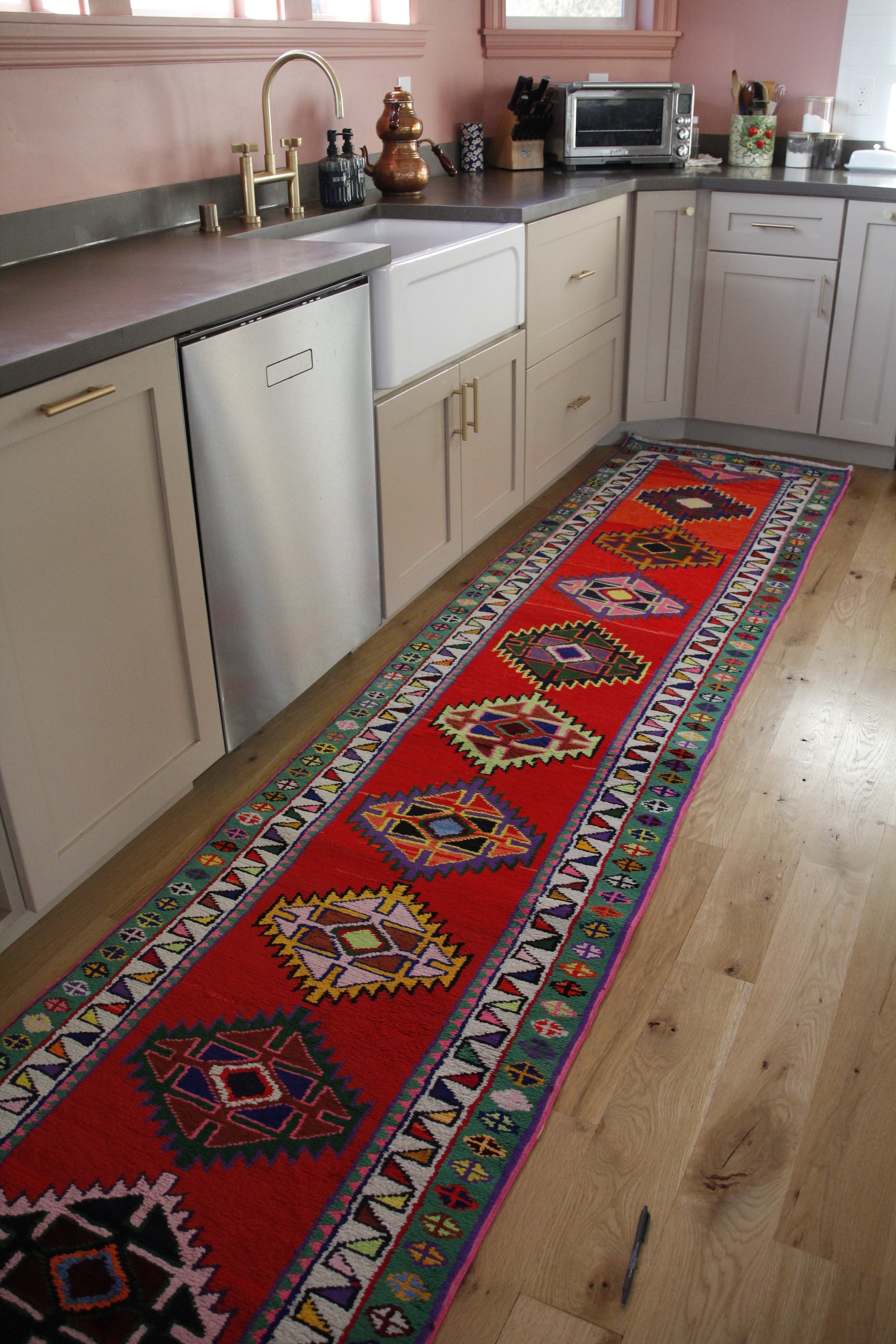 Handmade vintage Persian runner made of 100% cotton, featuring vibrant red, pink and green colors.