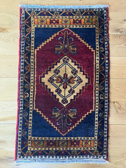 Handmade vintage Turkish entryway rug made of a cotton foundation and a wool pile, featuring  red and blue colors.