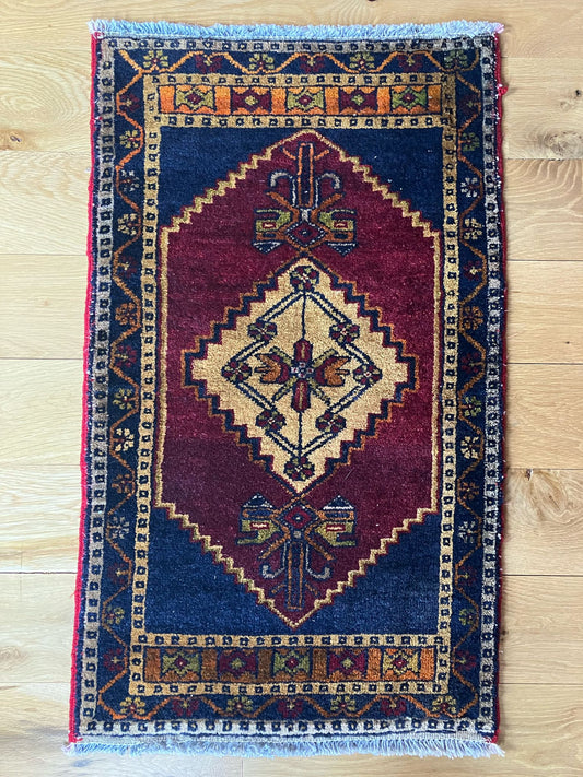 Handmade vintage Turkish entryway rug made of a cotton foundation and a wool pile, featuring  red and blue colors.
