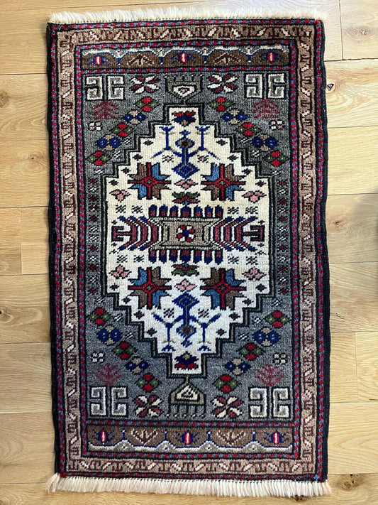 Handmade vintage Turkish entryway rug made of 100% wool, featuring blue, red, and beige colors.