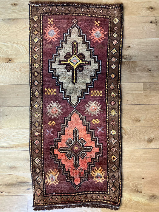 Handmade vintage Turkish entryway rug made of 100% wool, featuring red, beige, and brown colors.