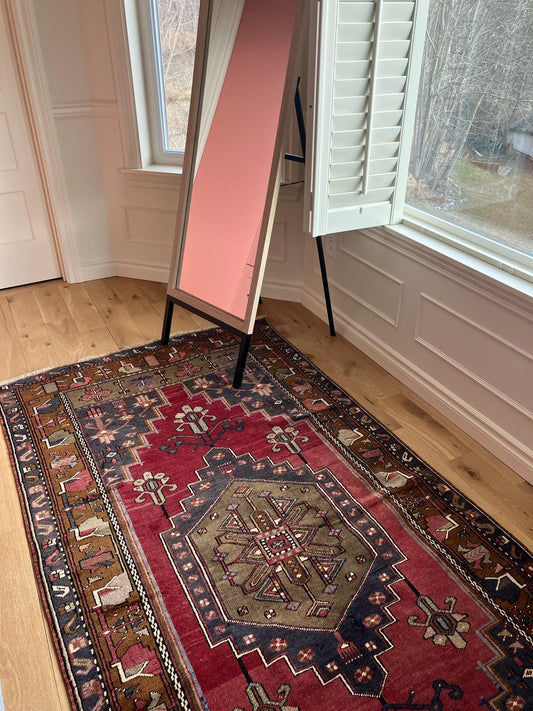 Handmade vintage Turkish medium rug made of 100% wool, featuring red, blue, and brown colors.     