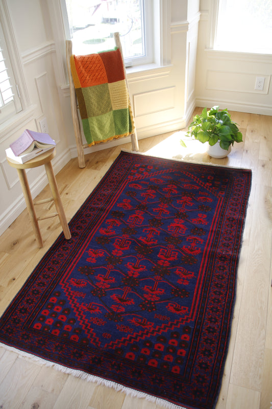 Handmade vintage Turkish medium rug made of 100% wool, featuring red and blue colors.    