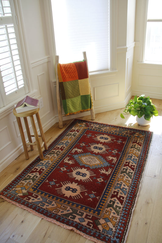 Handmade vintage Turkish medium rug made of 100% wool, featuring red, blue, yellow, and beige colors.    
