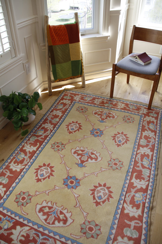 Handmade vintage Turkish medium rug made of 100% wool, featuring red, blue, and beige colors.    
