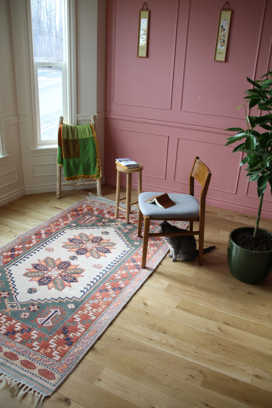 Handmade vintage Turkish medium rug made of 100% wool, featuring red, blue, green, and beige colors.    