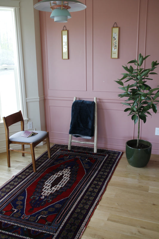 Handmade vintage Turkish medium rug made of 100% wool, featuring red and blue colors.