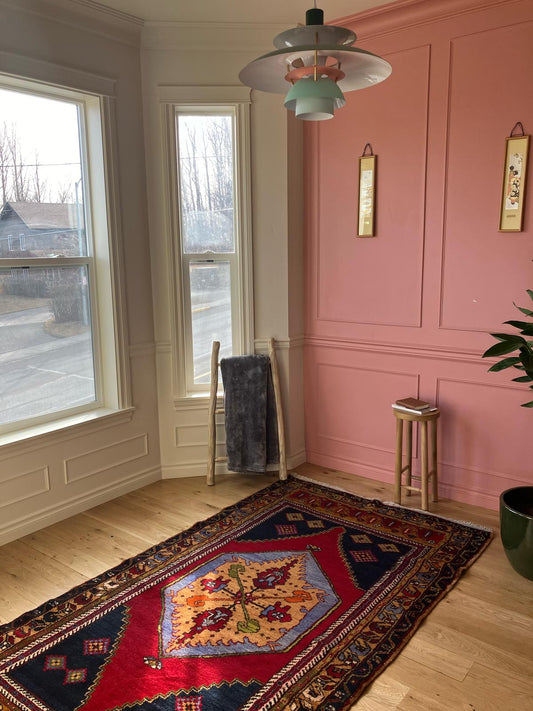 Handmade vintage Turkish medium rug made of 100% wool, featuring red  and blue colors.     