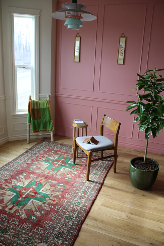Handmade vintage Turkish medium rug made of 100% wool, featuring red, green, beige, and brown colors.    