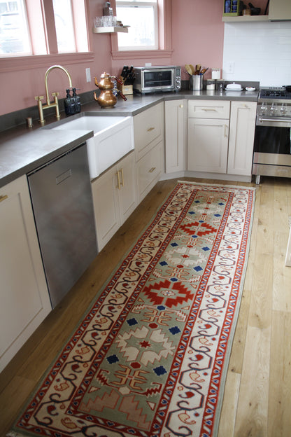 Handmade vintage Turkish runner made of 100% wool, featuring red, blue, and green colors.    
