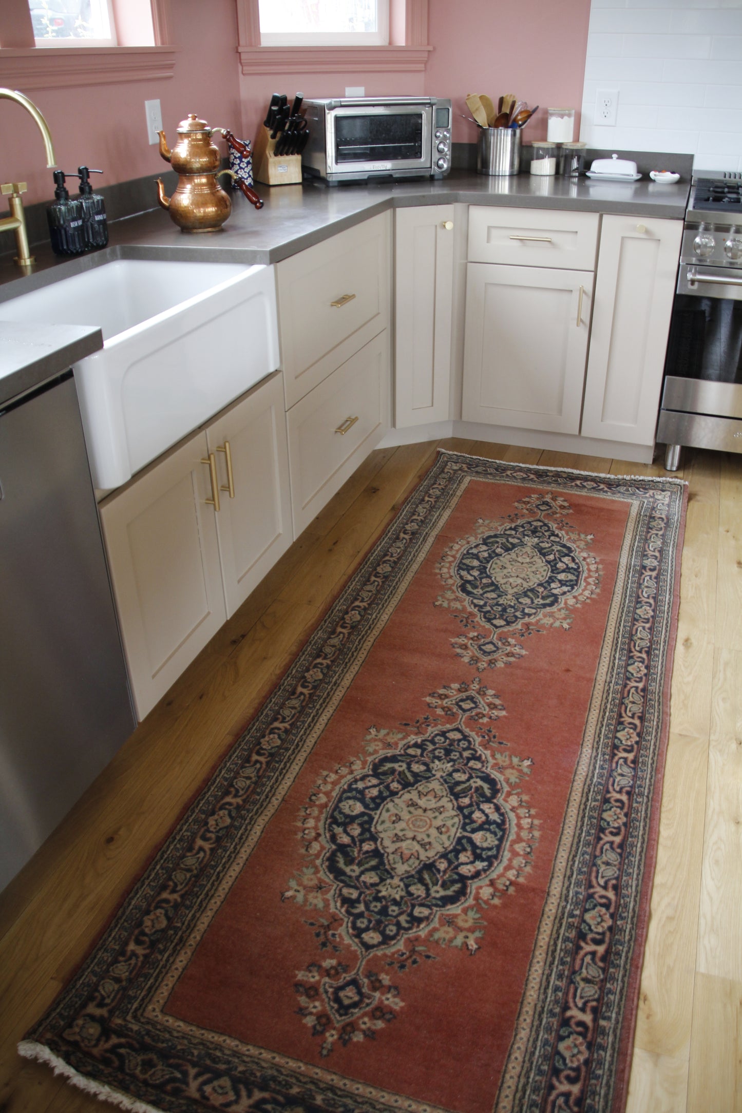 Handmade vintage Turkish runner made of a cotton foundation and a wool pile, featuring  red and black colors.