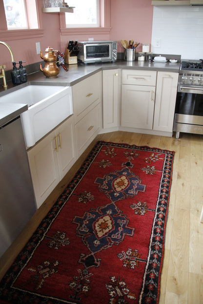 Handmade vintage Turkish runner made of 100% wool, featuring red, blue, and black colors.    