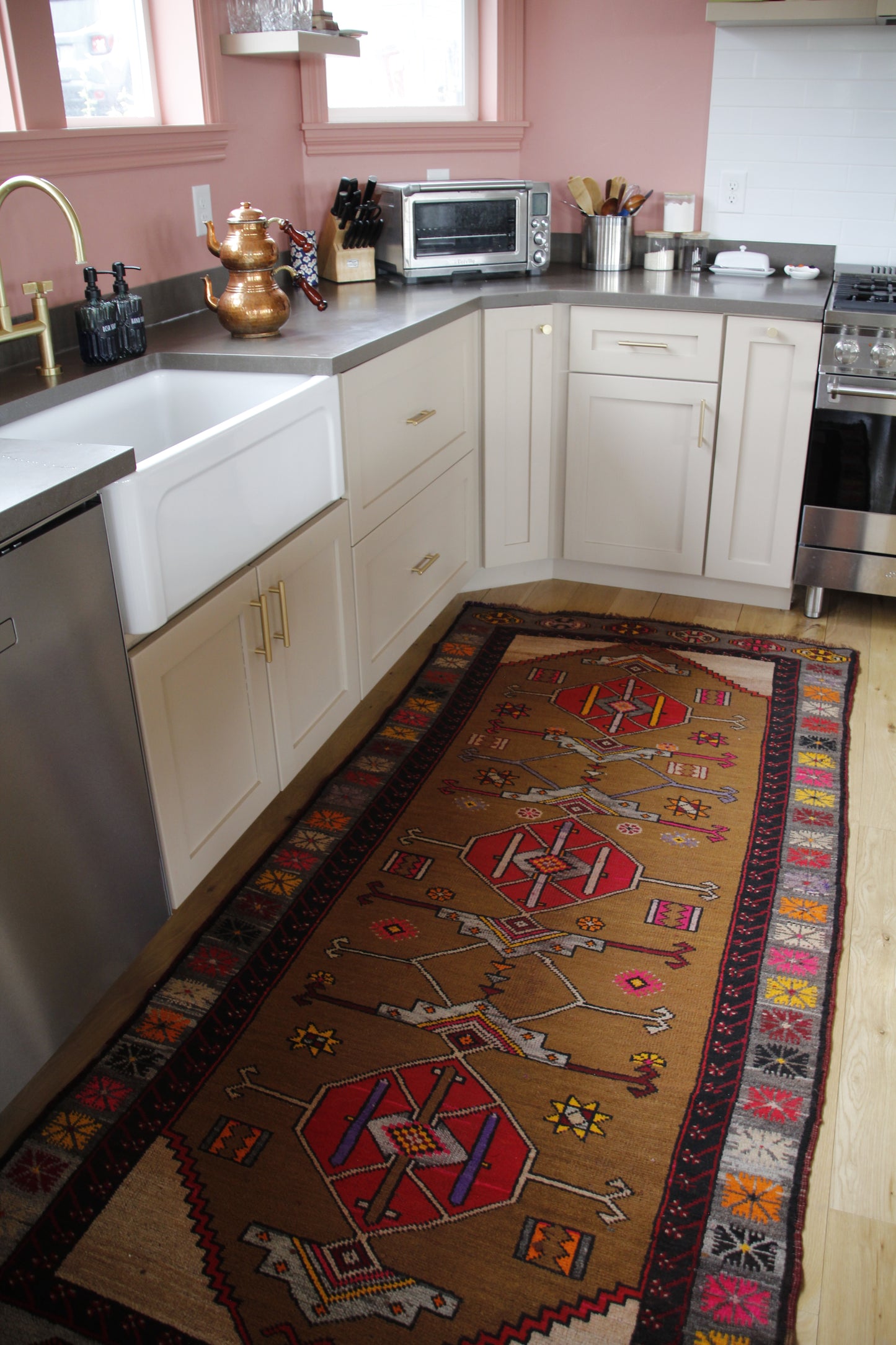 Handmade vintage Turkish runner made of 100% wool, featuring red, pink, yellow, and brown colors.    