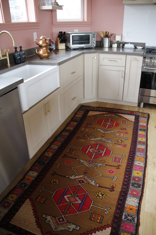 Handmade vintage Turkish runner made of 100% wool, featuring red, pink, yellow, and brown colors.    