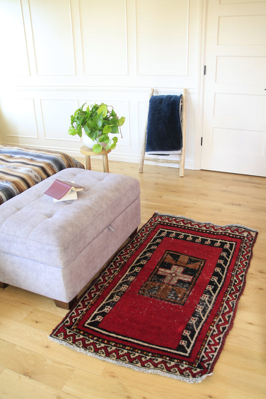 Handmade vintage Turkish small rug made of a cotton foundation and a wool pile, featuring  red color.