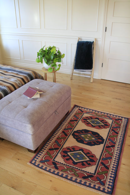 Handmade vintage Turkish small rug made of a cotton foundation and a wool pile, featuring  pink, blue, and beige colors.
