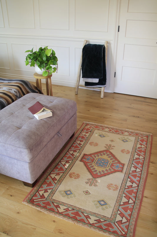Handmade vintage Turkish small rug made of 100% wool, featuring beige color.