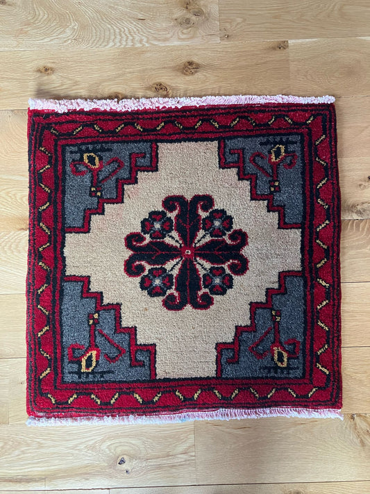 Handmade vintage Turkish entryway rug made of a cotton foundation and a wool pile, featuring  red and beige colors.