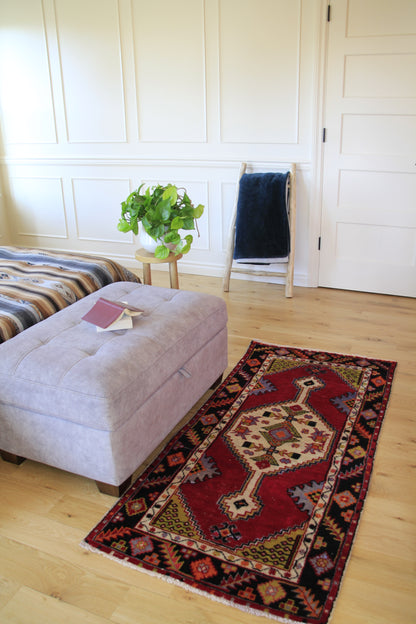 Handmade vintage Turkish small rug made of a cotton foundation and a wool pile, featuring  red and black colors.