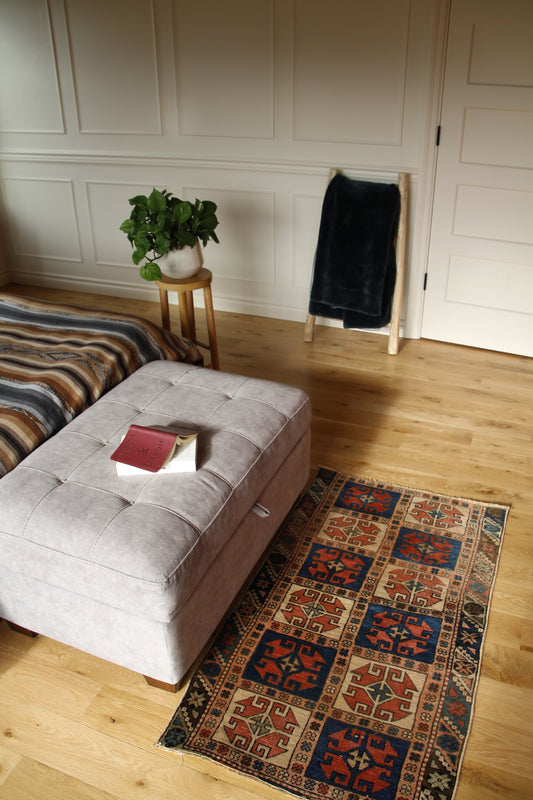 Handmade vintage Turkish small rug made of 100% wool, featuring red, blue, and beige colors.    