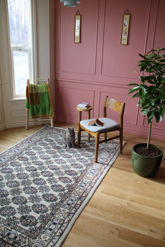 Handmade vintage Turkish medium rug made of a cotton foundation and a wool pile, featuring  pink, blue, and beige colors.